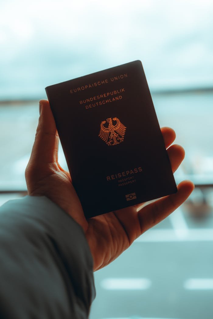 Close-up of a person holding a German passport, ideal for travel themes.